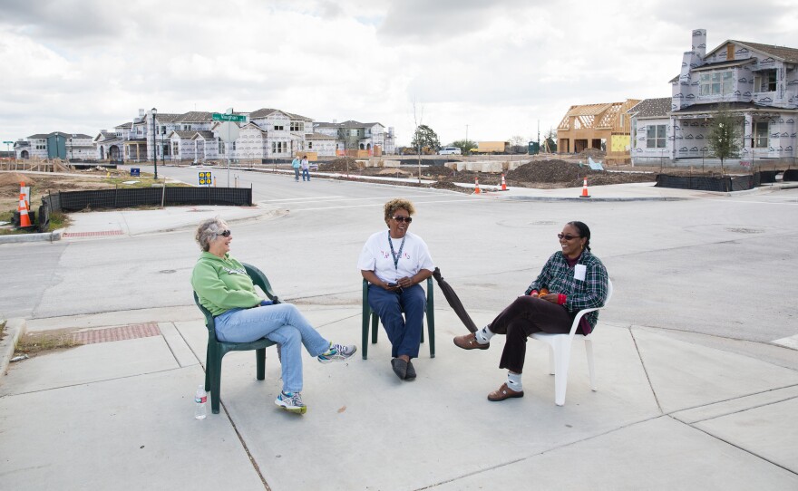 Kathy Van Sluyters (left), Barbara Carr and Colleen Dickinson chat on a recently finished sidewalk across from Wildflower Terrace, a mixed-income apartment building in the Mueller development for people 55 and over.