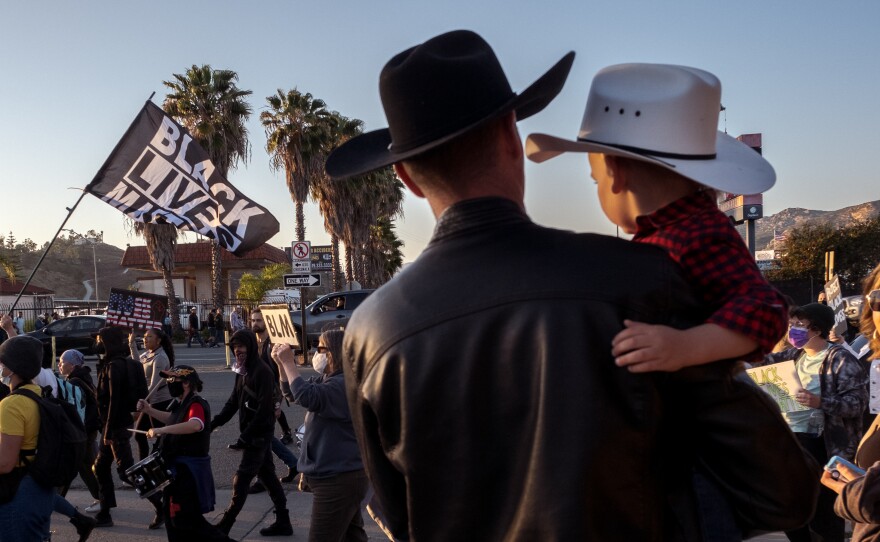 Families on there way to the Lakeside Rodeo paused to watch about 50 protesters marching because of a stabbing of a teenage black girl by a 16-year-old white boy in an apparent hate crime and to draw attention to what they say is "The mishandling of the case by police just emphasizes the systematic issues we face in addition to the discrimination from our own neighbors", April 23, 2022.