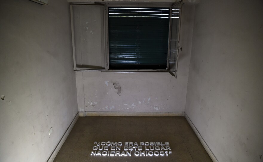 A room where prisoners were kept hooded and chained at ESMA is shown on March 19, 2016. The inscription on the floor reads "How could children possibly have been born in this place?"