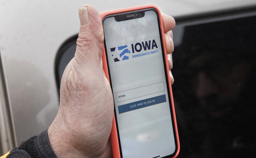 Precinct captain Carl Voss of Des Moines displays the Iowa Democratic Party caucus reporting app on his phone outside the Iowa Democratic Party headquarters on Tuesday.