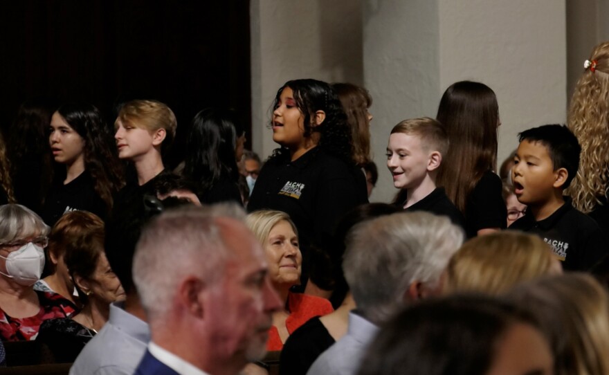 Members of the Bach Festival Youth Choir play for an audience.