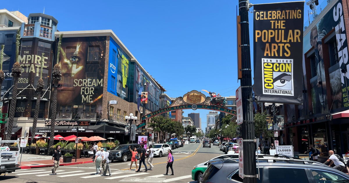 People walk around the Gaslamp District in downtown San Diego, where buildings are dressed up for Comic-Con on July 22, 2025