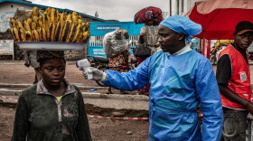 A health worker takes a woman's temperature as part of Ebola screening efforts in Goma, Democratic Republic of Congo. As part of the effort to quash the outbreak, the first patients have been enrolled in a clinical trial to test two drugs against the Bundibugyo strain of the virus that is spreading there. In addition, researchers plan to study whether another drug could protect people exposed to the virus.