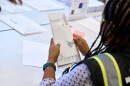 A Wake County Board of Elections employee prepares a mail-in ballot to be sent out to a voter in September in Raleigh, N.C.