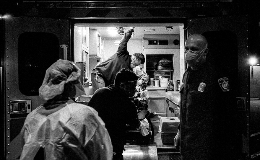 A Los Angeles Fire Department crew gives a report to a physician.