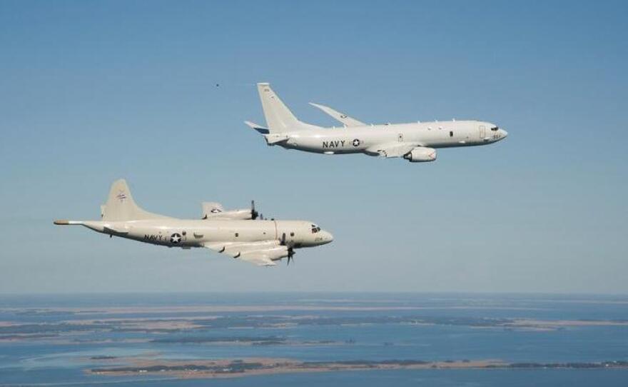 A P-8A Poseidon (top) and a P-3 Orion are shown flying off the coast of Maryland.