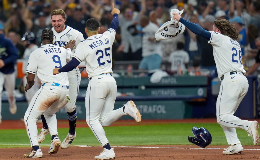 Tampa Bay Rays shortstop Jorge Mateo (9) and right fielder Victor Mesa Jr. (25) celebrate with Tampa Bay Rays second baseman Ben Williamson after his walk-off RBI single during the 12th inning of Game 4 of baseball's World Series, Wednesday, Oct. 28, 2026, in St. Petersburg, Fla., between the Milwaukee Brewers and the Tampa Bay Rays.