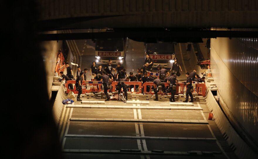 Hong Kong police dismantle barricades previously set up by pro-democracy protesters from the Occupy Central movement in Admiralty District of Hong Kong on Wednesday.