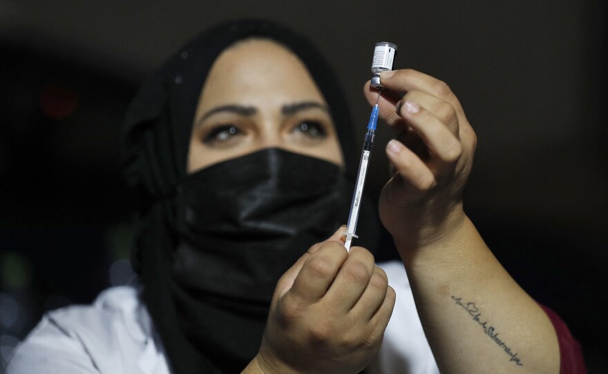 An Israeli health worker prepares to administer a third dose of the Pfizer-BioNtech Covid-19 vaccine to Jewish ultra-Orthodox people at a religious neighborhood in Jerusalem on August 19, 2021.