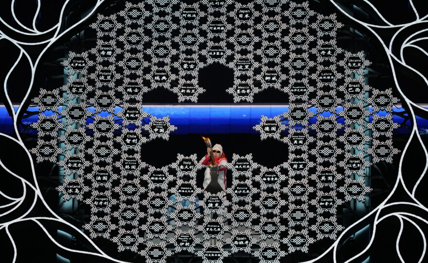 Retired Chinese Paralympian Li Duan lights the cauldron during the opening ceremony at the 2022 Winter Paralympics in Beijing.