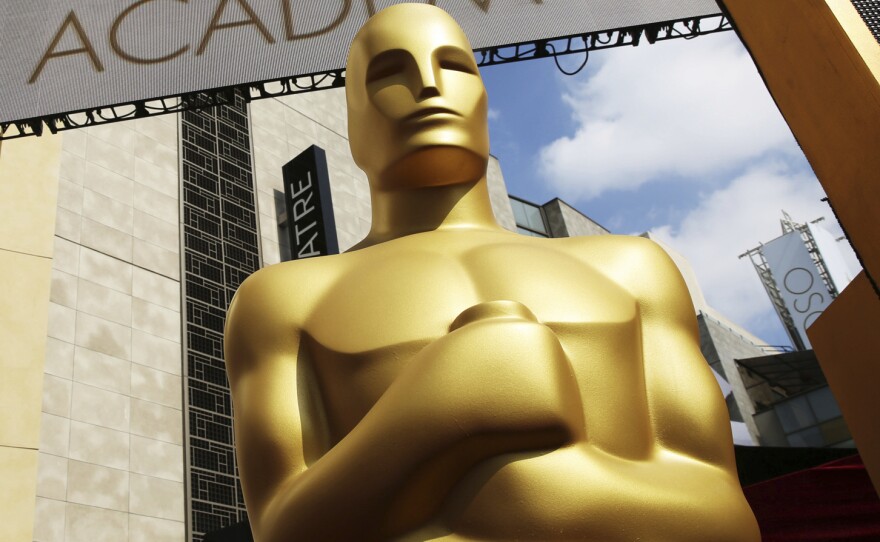An Oscar statue appears outside the Dolby Theatre ahead of the 2015 ceremony. But who is he really?