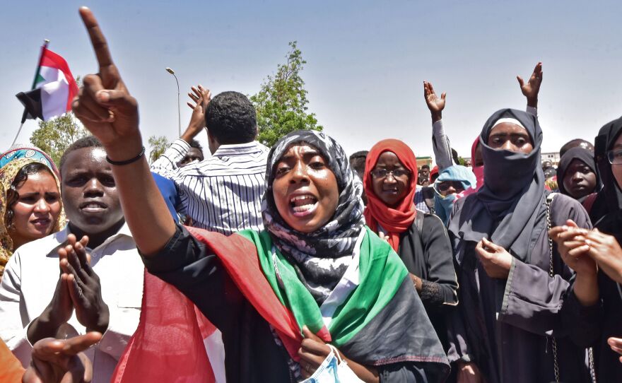 Sudanese demonstrators gather near military headquarters in the capital Khartoum on Monday. Organizers said they were resisting an attempt to disperse the sit-in where thousands of people have camped out for days.