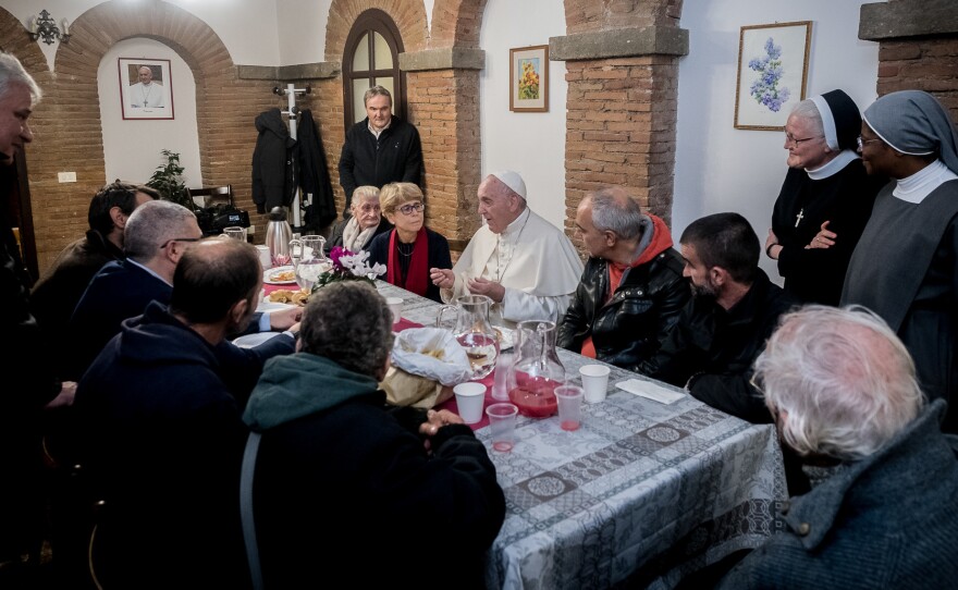 Pope Francis shares a meal with guests and volunteers of the "Palace of the Poor."