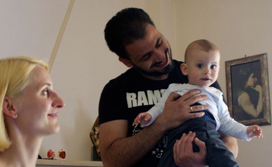 Vassilis Pergantas, center, first met his wife Claudia when she visited Distomo, Greece, on a trip with her youth group from Nuremberg, Germany. Despite the massacre committed by the Nazis in the village, Claudia says her husband's family has been very welcoming. The two now have a 9-month-old son, Lukas.