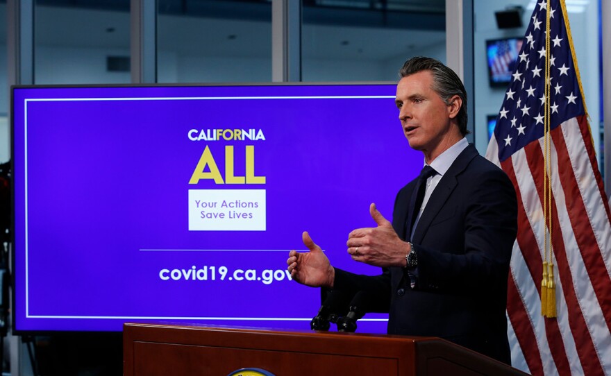 n this photo taken Tuesday, April 14, 2020, Gov. Gavin Newsom discusses an outline for what it will take to lift coronavirus restrictions during a news conference at the Governor's Office of Emergency Services in Rancho Cordova, Calif.