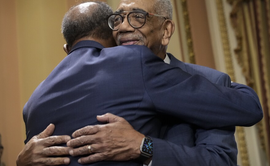 Rep. Bobby Rush, D-Ill., right, hugs radio host Joe Madison as they arrive for a bill enrollment ceremony for the Emmett Till Antilynching Act at the Capitol on March 16, 2022, after the House passed the legislation.