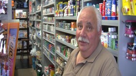 Ken Gabarra, owner of Paras News, sits at his front counter, talking about his concerns for parking in the city's plan to revamp University Avenue in North Park.