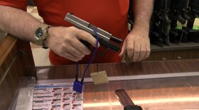 A trigger lock is displayed on a handgun at Discount Gun Mart, July 30, 2019.