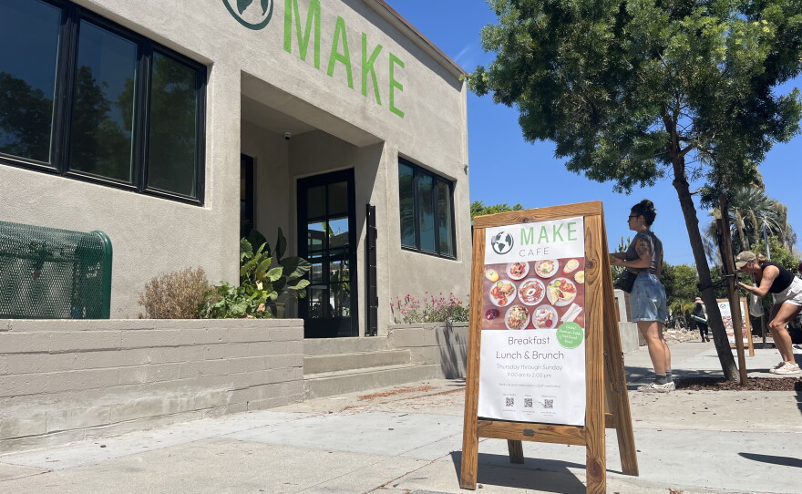 A couple of women stand in front of the Make Cafe building in Normal Heights, Aug. 21, 2026.