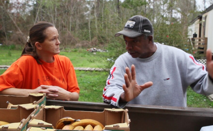 Food pantry volunteer, Roosevelt Harris of Bayou La Batre, Alabama, distributing food.