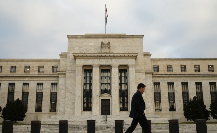 A man walks past the Federal Reserve in Washington, D.C., on Wednesday.