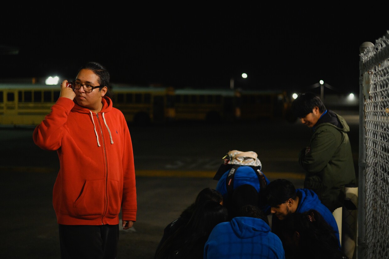 Chula Vista High School students listen to an online livestream of the Sweetwater District board meeting during a rally outside the district offices in Chula Vista, California on Jan. 30, 2024.