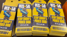Door hangers in support of Prop 50. They read "Stop Trump's Power Grap" and "Alto al abuso de poder de Trump"