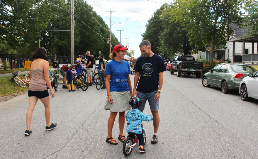 O'Neill and fellow bike lane advocate Brendan Hogan stand with Hogan's son George on a blocked off street during Open Streets in Burlington.
