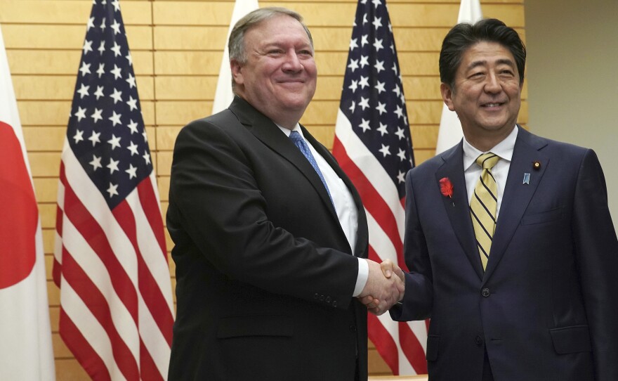 U.S. Secretary of State Mike Pompeo shakes hands with Japanese Prime Minister Shinzo Abe in Tokyo on Saturday. The two met before Pompeo's planned Sunday meeting with North Korean leader Kim Jong Un.