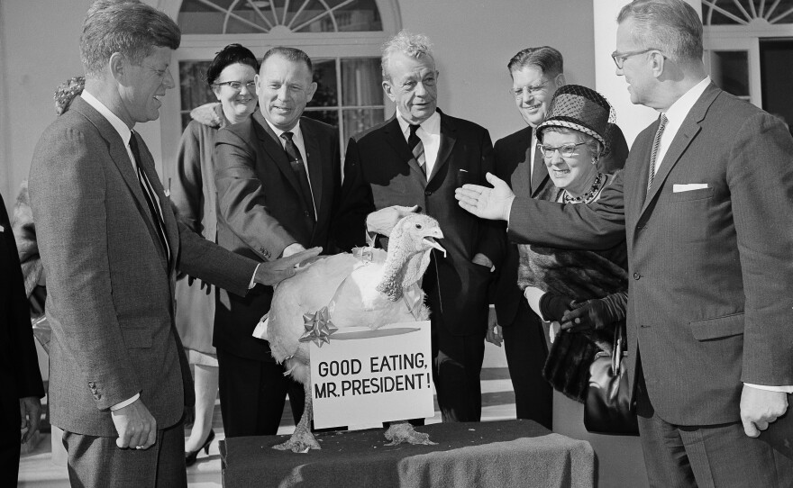 President John F. Kennedy reaches out to touch a 40-pound turkey at the White House in 1963. The presentation was made on behalf of the nation's turkey industry.