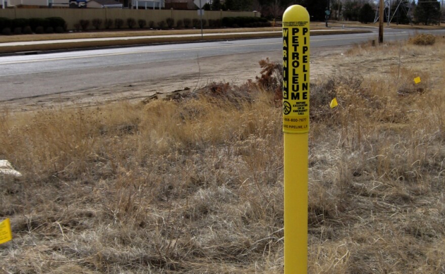 In Colorado, yellow warning poles designate the underground path of a gas pipeline.