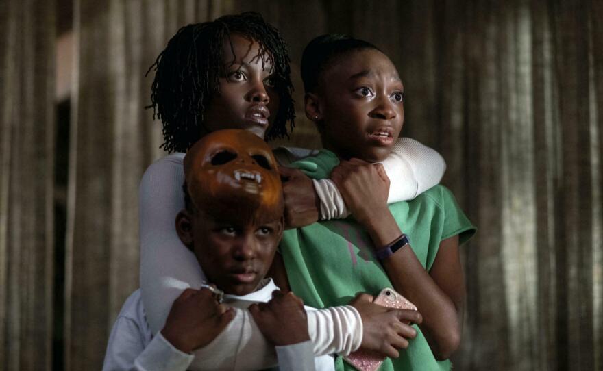 Lupita Nyong'o hugs her children, played by Evan Alex and Shahadi Wright Joseph, in the 2019 film, <em>Us,</em> written and directed by Jordan Peele.