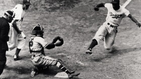 Jackie Robinson slides home for the Brooklyn Dodgers.