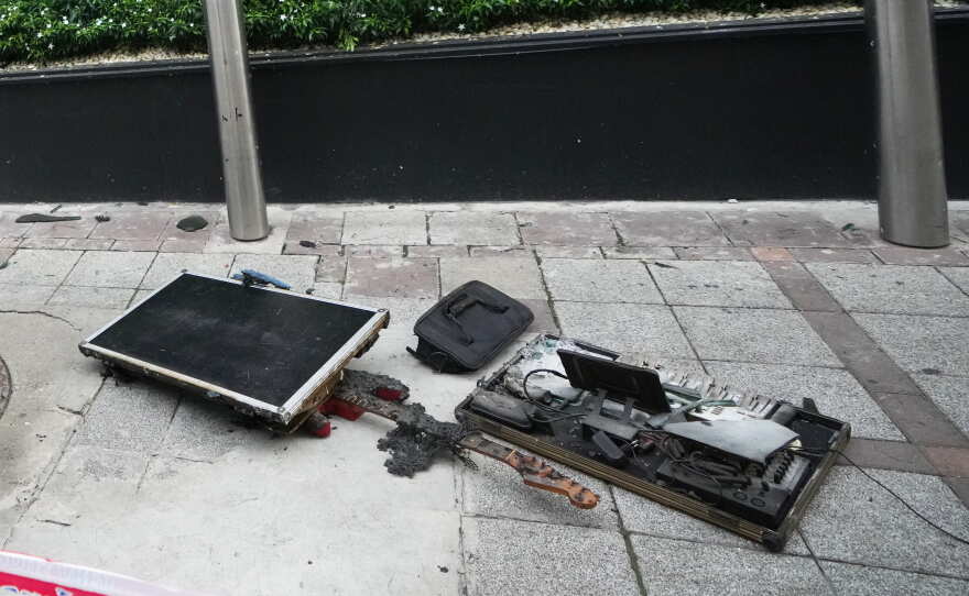 Burned musical instruments sit in front of a music bar fire in Bangkok, Thailand, Monday, July 13, 2026.