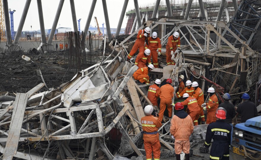 In this photo released by Xinhua News Agency, rescue workers look for survivors after a work platform collapsed at a power plant in eastern China's Jiangxi Province on Thursday.