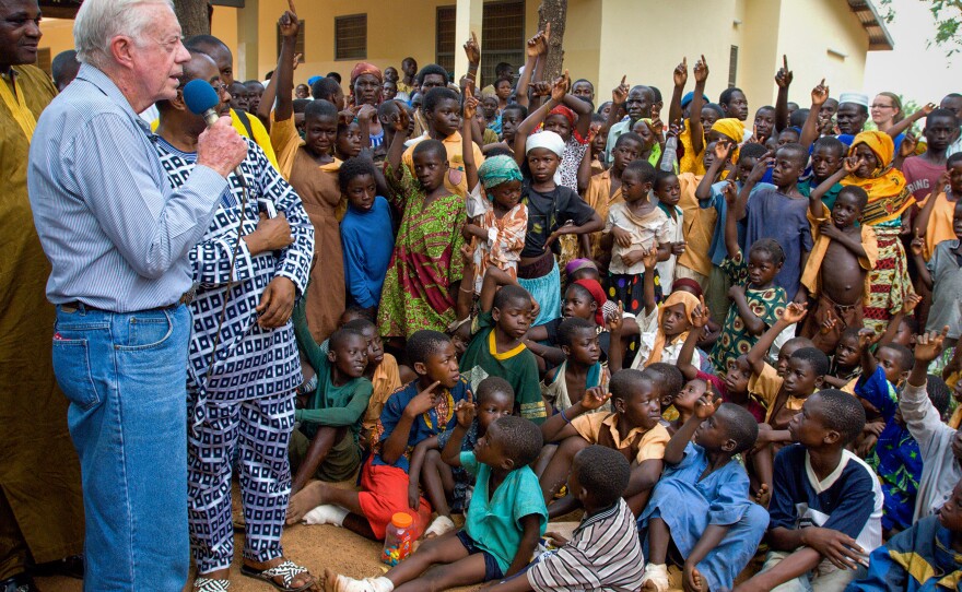 On a 2007 visit to Savelugu Hospital in Ghana, President Jimmy Carter asks a group of children if they've had Guinea worm. A raised hand is a yes.