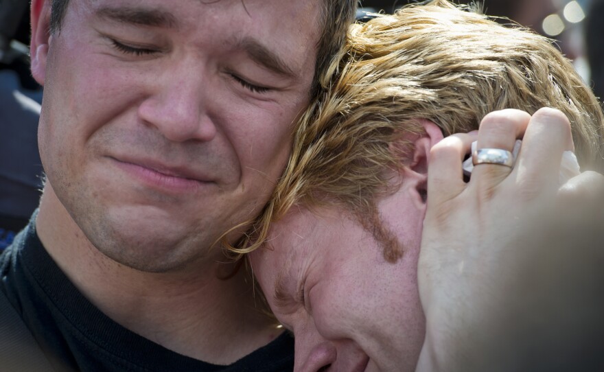 Michael Knaapen (left) and his husband, John Becker, embrace outside the Supreme Court after news of the justices' ruling. DOMA prohibited married gay couples from receiving the same federal benefits that straight couples are granted.