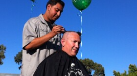 Principal Armando Farias has his head shaved at Baker Elementary, Oct. 26, 2012. Farias promised students if they raised the school's academic performance score, he would shave his head or dye his har. The students chose head shaving.
