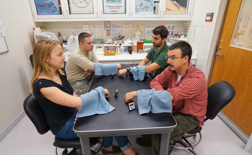 In this 2015 demonstration, volunteers are bitten by ordinary mosquitoes at the Walter Reed Army Institute of Research in suburban Washington. In other instances, volunteers are bitten by malaria-infected mosquitoes so the military can see how people respond to treatment.