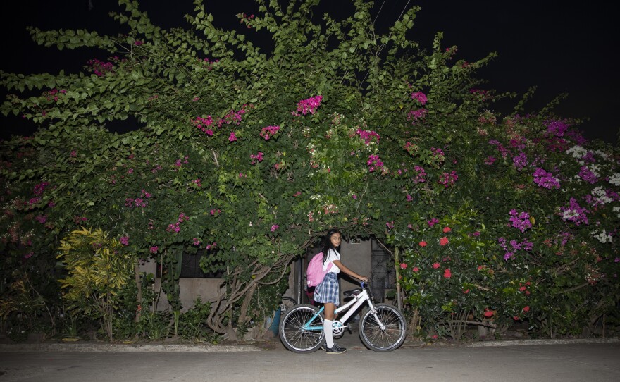 Mariangel returning from school in 2022. "I like biology, physics; I also like art and mathematics ... I also like photography, and I really like sewing and inventing. And continue with dance and instruments," Mariangel Tumay says. "I would like to have several careers to have several possibilities."