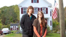 Sue Spencer, 50, stands with her daughter Gaelyn Spencer, 17, in front of their home in Marlborough, N.H.