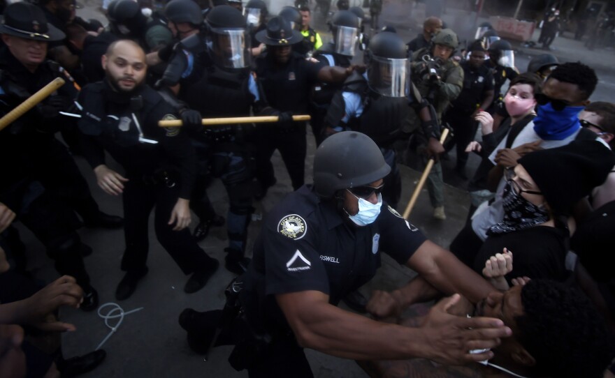 Police officers and demonstrators get into a scuffle during a protest that took place in May, over the killing over George Floyd and police brutality.