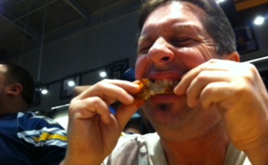 Brian Ochaba bites into the blazin' wings challenge at Buffalo Wild Wings, Jan. 5, 2014.