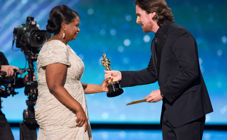 Octavia Spencer accepts her award from Christian Bale.