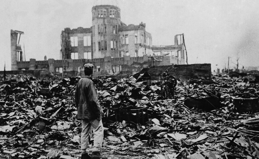 One month after the atomic bomb was dropped on Hiroshima, a man stands amid ruins left by the explosion. The structure seen standing became the Hiroshima Peace Memorial, which President Obama visited Friday.