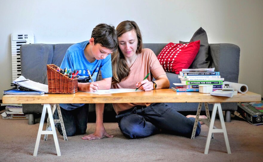 Natalie Dunnege and her son, Strazh, work on an art project at home in San Francisco. Her health insurance would cover therapy sessions to help with her depression, Dunnege says, but she hasn't been able to find a counselor who is taking new patients.