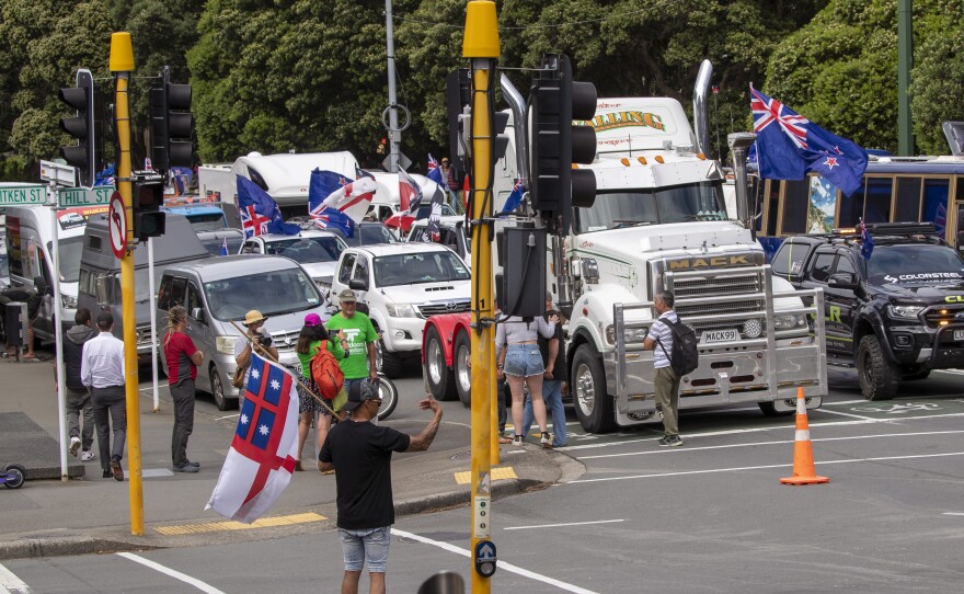 A convoy of vehicles block an intersection near New Zealand's Parliament in Wellington on Tuesday. Hundreds of people protesting vaccine and mask mandates drove in convoy to New Zealand's capital and converged outside Parliament as lawmakers reconvened after a summer break.