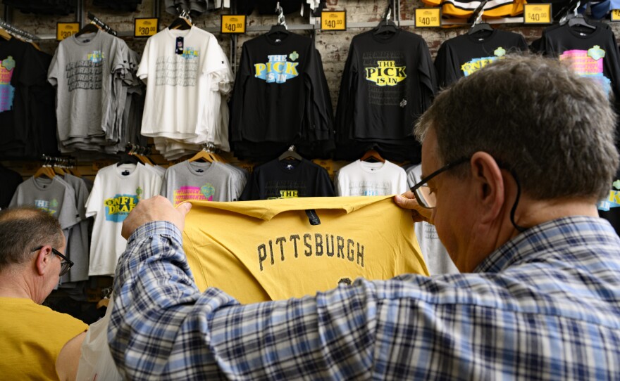 A customer checks out a T-shirt at a Pittsburgh souvenir shop, Yinzers in the Burgh.