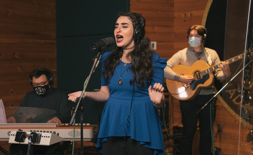 From left, Ron Adea (keyboards), Rawan Tuffaha (vocals) and Jackson D. Begley (guitar) perform during a virtual media appearance on Tue, Oct. 6, 2020 at Metalworks Studios in Mississauga, Ontario, Canada.