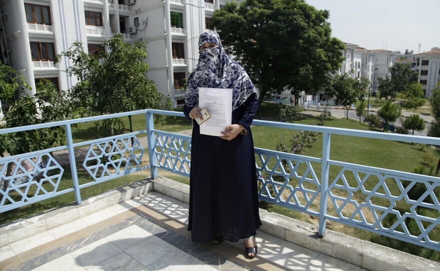 Lawmaker Naeema Kishwar Khan, who represents a conservative Islamic party, holds up the transgender rights bill she submitted to Pakistan's Parliament in August. It provides for the establishment of separate jail cells, enshrines their right to medical treatment and education, penalizes discrimination and mandates a quota of government jobs.